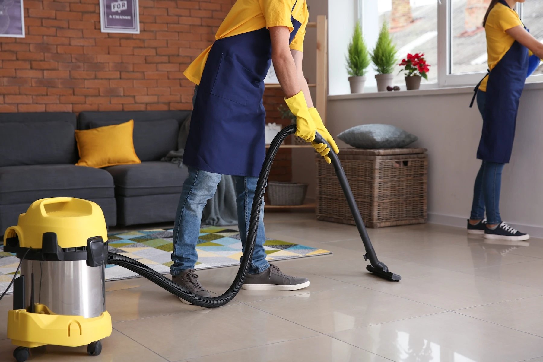 Cleaner vacuuming a living room