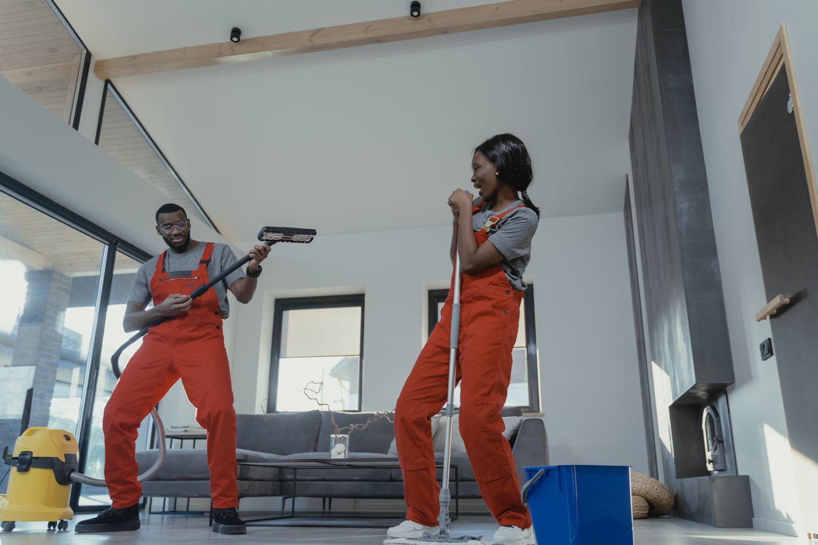 A cleaner vacuuming a bright living room